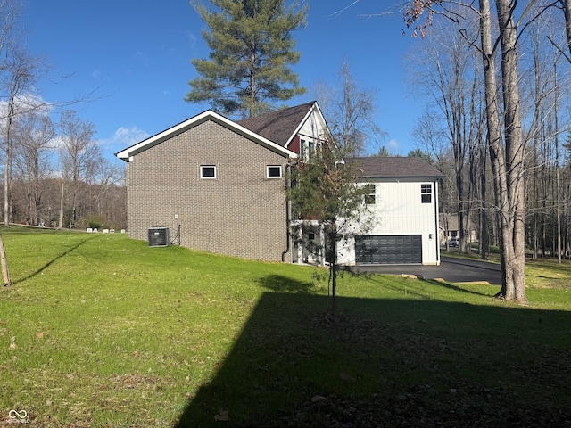 view of property exterior featuring a lawn, cooling unit, and a garage