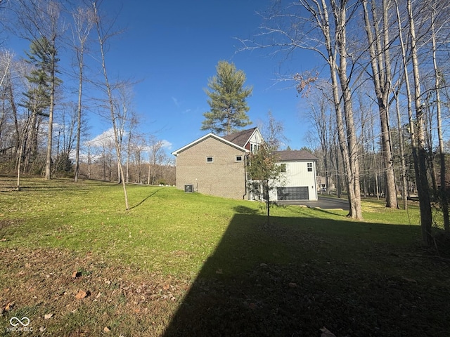 3380 N Pine Song Dr, Martinsville, IN 46151 - view of green lawn featuring a garage and driveway