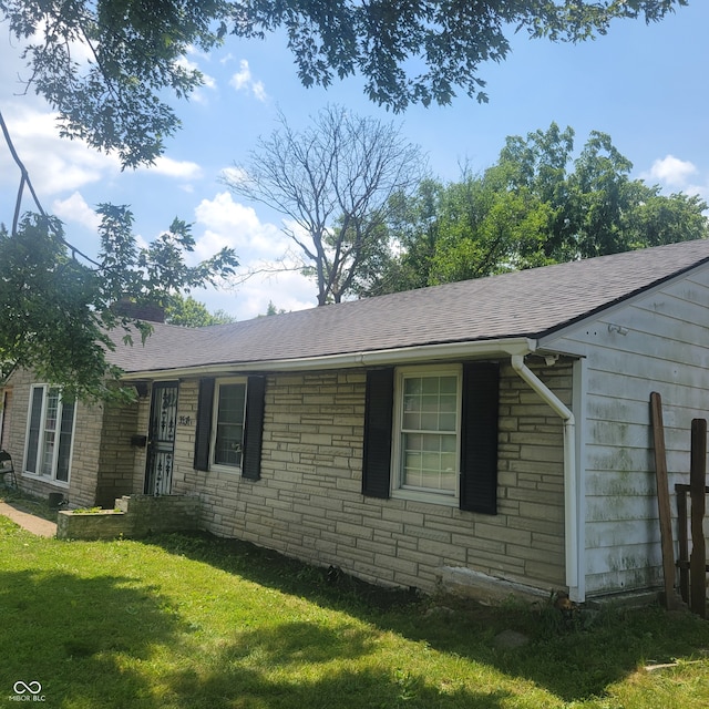 view of side of home with a yard