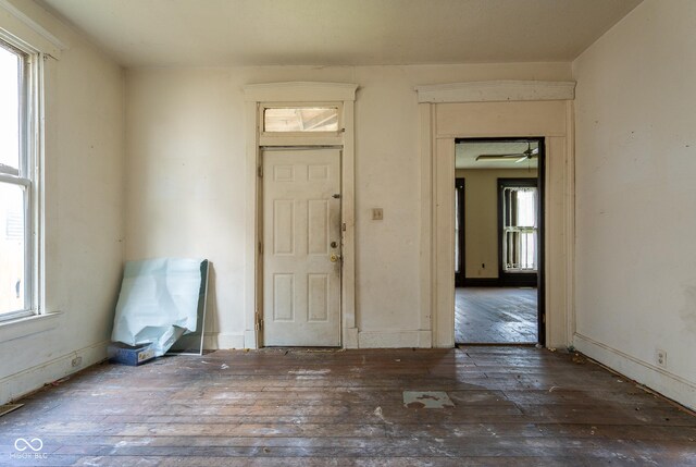 foyer featuring wood-type flooring and baseboards