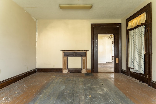 unfurnished room featuring wood-type flooring and baseboards