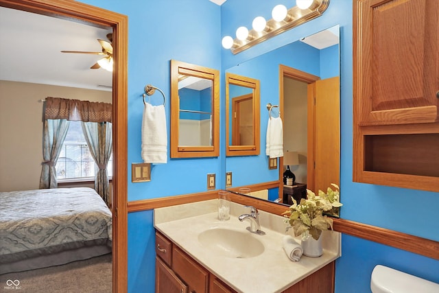 bathroom featuring vanity, toilet, and ceiling fan