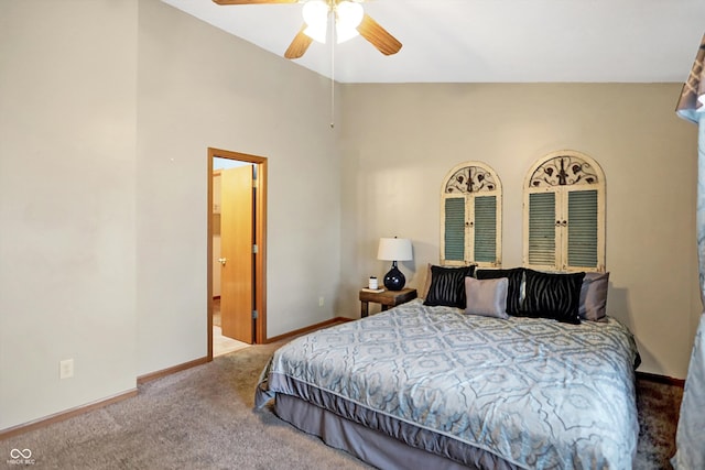 carpeted bedroom with ceiling fan and vaulted ceiling