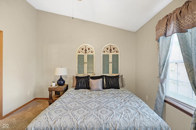 carpeted bedroom with lofted ceiling