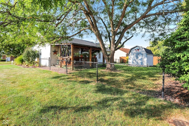 rear view of house with a lawn and a shed