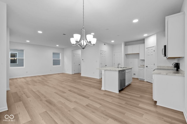 kitchen featuring white cabinetry, stainless steel appliances, light hardwood / wood-style flooring, pendant lighting, and a kitchen island with sink