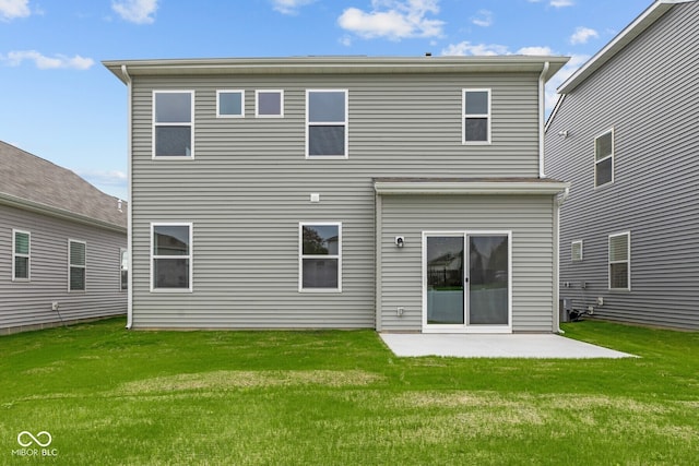 rear view of property featuring a lawn and a patio area