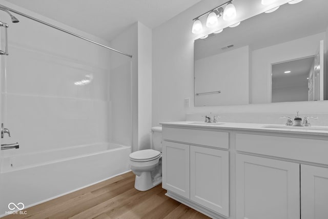 full bathroom with toilet, shower / washtub combination, vanity, and hardwood / wood-style flooring