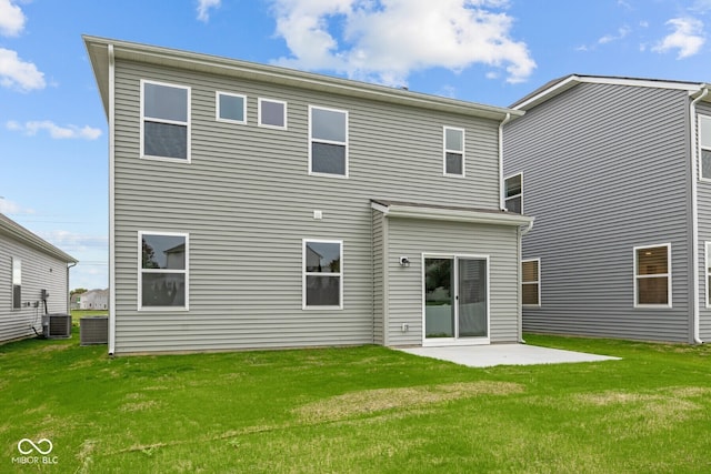 rear view of house featuring a lawn, a patio, and central AC unit