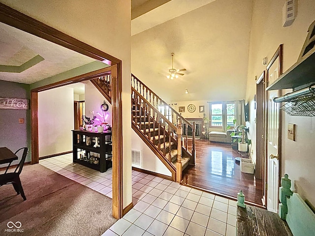 foyer entrance featuring vaulted ceiling, light hardwood / wood-style floors, and ceiling fan