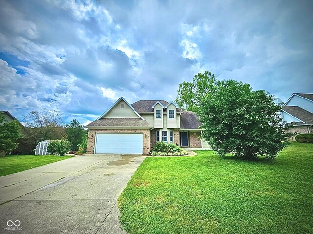 view of front of home with a front yard and a garage