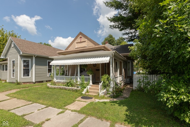 view of front of home featuring a porch and a front yard