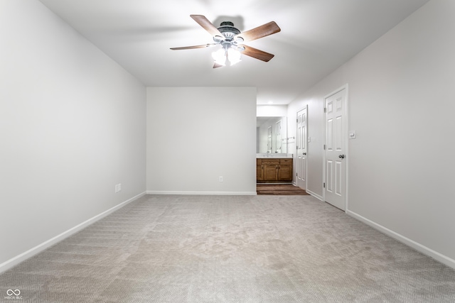 unfurnished bedroom with ensuite bath, ceiling fan, baseboards, and carpet