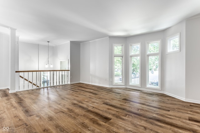 empty room featuring baseboards and wood finished floors