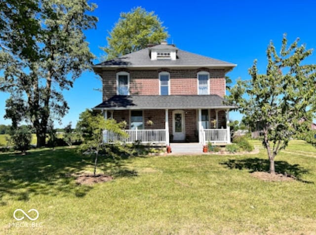 view of front of house with a front yard and covered porch