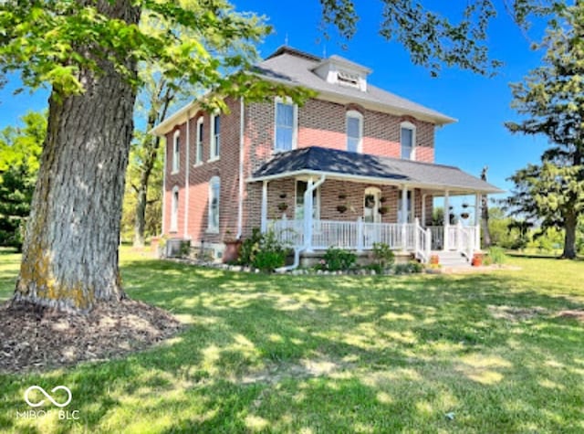 view of front facade with a front lawn and covered porch