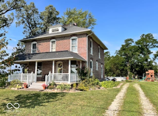 view of front of property with a porch, a front lawn, and a playground