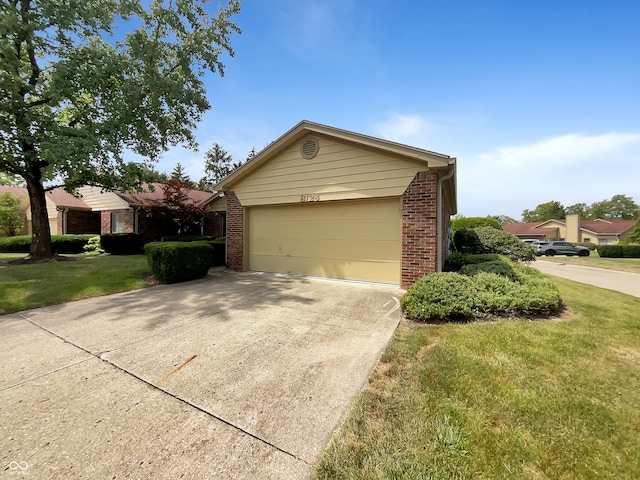 view of front of house featuring a garage and a front lawn