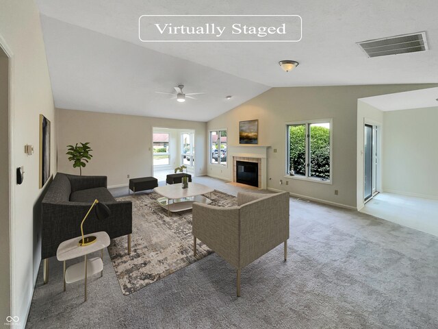 carpeted living room with ceiling fan and lofted ceiling