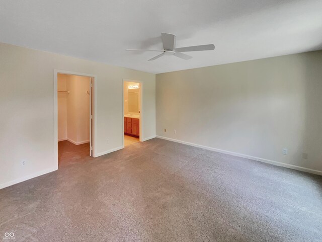 unfurnished room featuring ceiling fan and light carpet