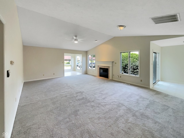 unfurnished living room with ceiling fan, light carpet, and lofted ceiling