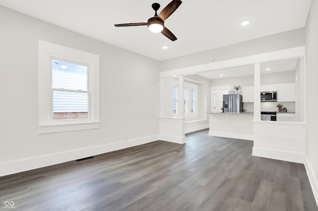 unfurnished living room featuring dark wood-style floors, recessed lighting, visible vents, and baseboards