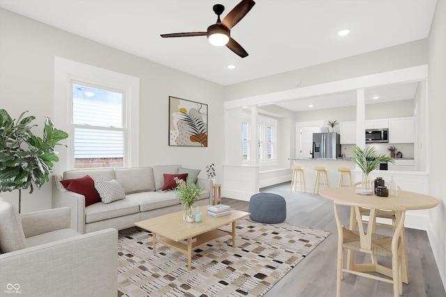 living room with recessed lighting, a ceiling fan, and light wood-style floors