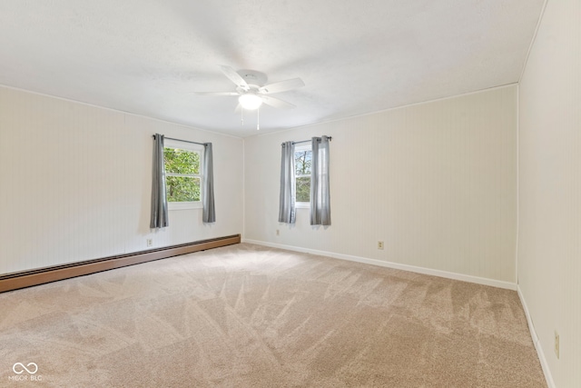 spare room featuring ceiling fan, light colored carpet, and baseboard heating