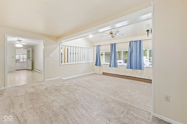 empty room with baseboard heating, light colored carpet, and a healthy amount of sunlight