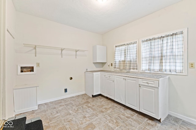 laundry area featuring washer hookup and cabinets