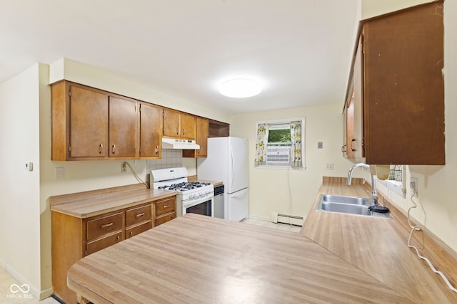 kitchen with tasteful backsplash, sink, white appliances, and a baseboard heating unit