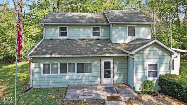 front of property featuring a front lawn and a patio