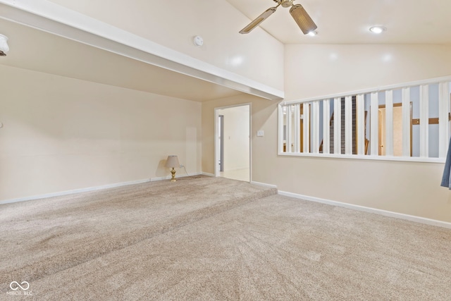 carpeted spare room featuring ceiling fan and lofted ceiling