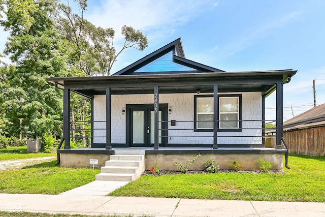 bungalow-style home with a porch and a front yard