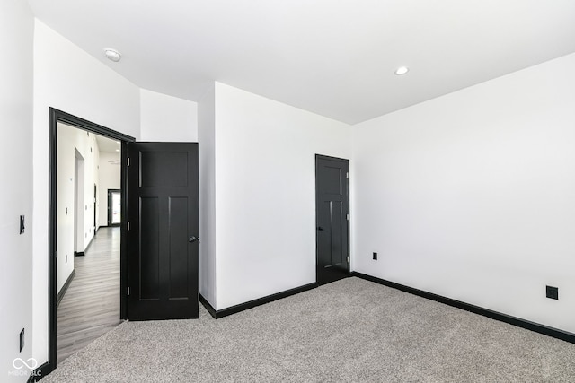 unfurnished bedroom featuring carpet flooring, recessed lighting, and baseboards