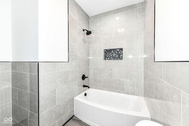 full bathroom with shower / tub combination and tile walls