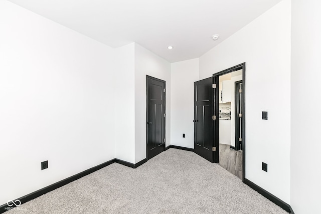 unfurnished bedroom with recessed lighting, baseboards, and carpet flooring