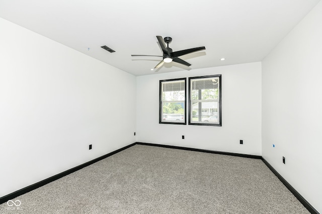 spare room with visible vents, baseboards, carpet floors, and a ceiling fan