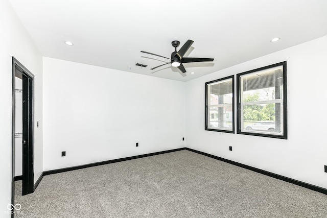 carpeted empty room featuring recessed lighting, baseboards, visible vents, and ceiling fan