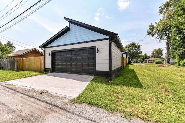 detached garage featuring fence