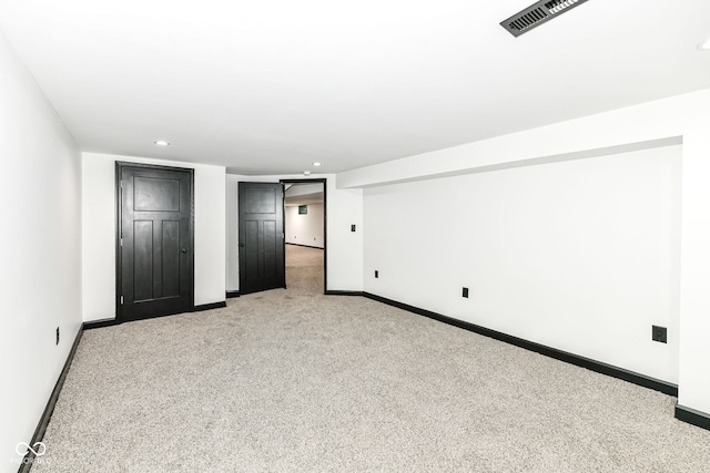 unfurnished bedroom featuring recessed lighting, visible vents, light colored carpet, and baseboards