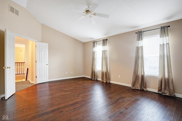 spare room featuring ceiling fan, dark hardwood / wood-style flooring, and vaulted ceiling