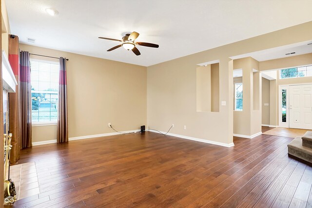 unfurnished room with plenty of natural light and dark hardwood / wood-style flooring