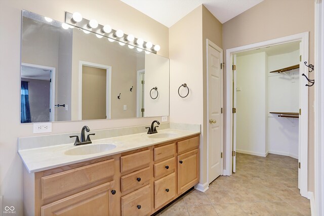 bathroom featuring tile patterned flooring and vanity