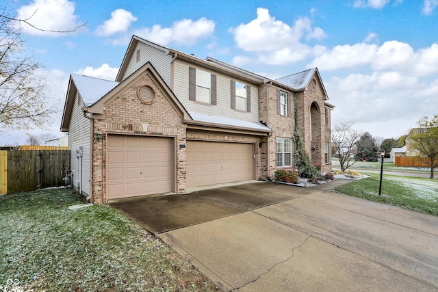 view of front of home featuring a garage and a front yard