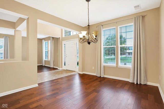 entryway featuring dark hardwood / wood-style flooring and a notable chandelier