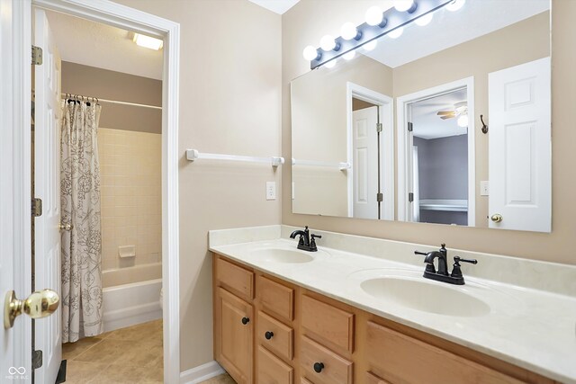 bathroom with vanity, tile patterned floors, ceiling fan, and shower / bath combo with shower curtain