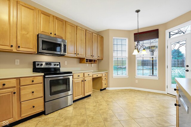 kitchen with light brown cabinetry, hanging light fixtures, stainless steel appliances, and an inviting chandelier