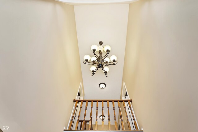 staircase featuring an inviting chandelier