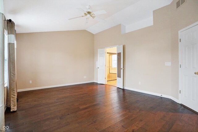 spare room featuring ceiling fan, lofted ceiling, and dark wood-type flooring